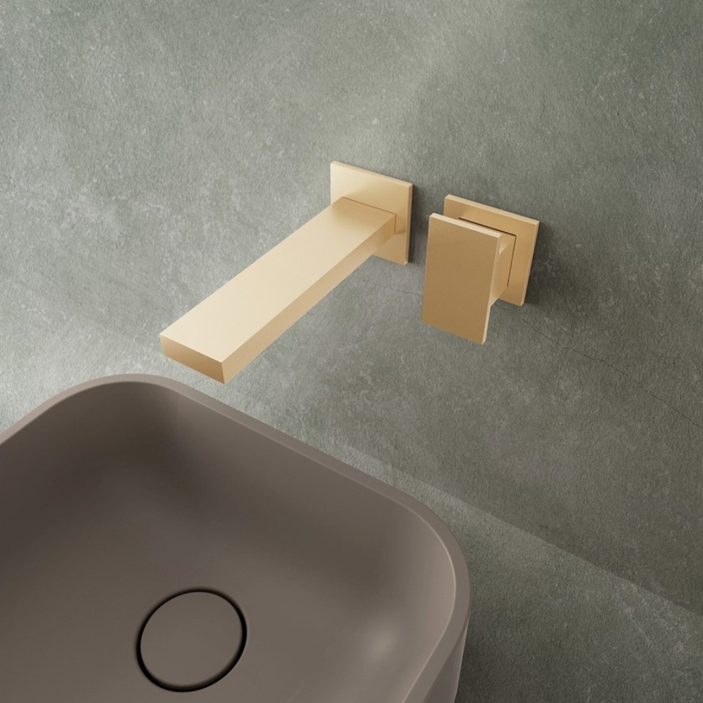 Lifestyle image of the Crosswater Myron Brushed Brass Wall Mounted Basin Mixer mounted behind a countertop basin